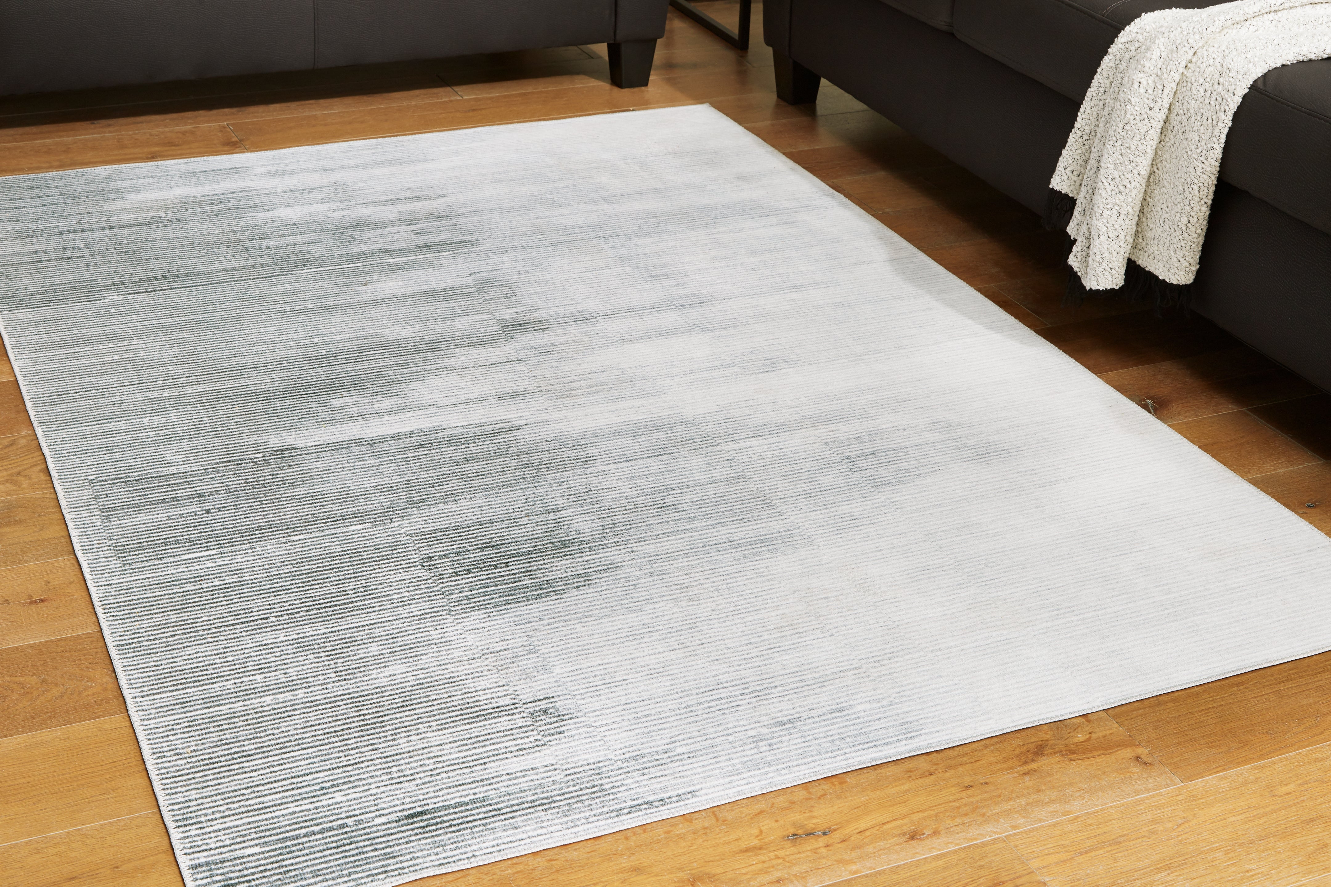 Tampa Furniture Outlet Lutz - Ashley Furniture - Milset Rug - 5'1" x 6'10" Washable Rug / Black/White/Gray - R406252